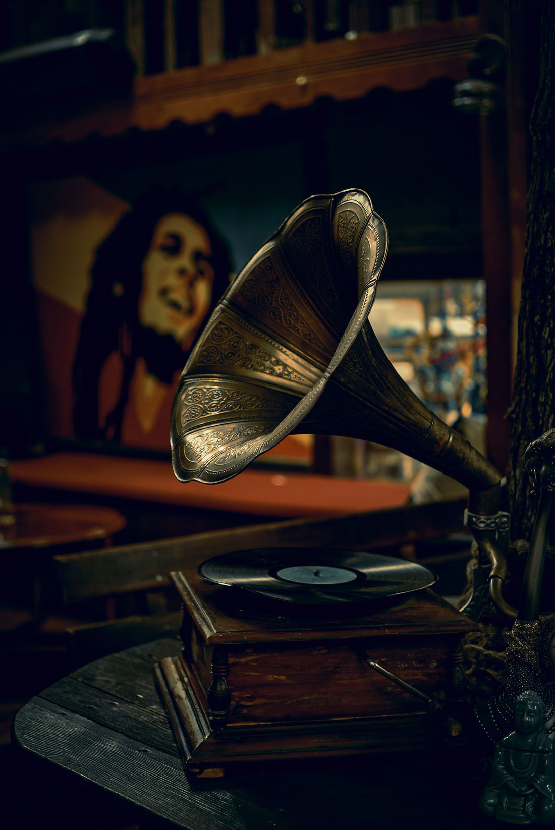 Vintage gramophone playing music with a Bob Marley poster in the background, symbolizing Jamaica’s reggae legacy, global influence, and the evolution of Caribbean music from roots to international success.